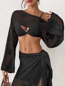 Detailed view of black crochet heart hollow knit top and wrap skirt for beach vacations