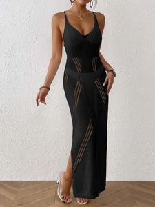 Detailed close-up of black pointelle knit beach dress with geometric cutouts and slit