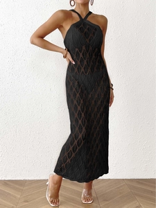 Detail of black crochet halter maxi dress with hollow leaf pattern and diamond weave texture