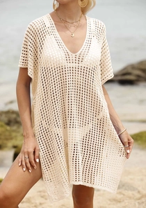 Close-up of beige crochet hollow-out knit beach cover-up with textured mesh V-neck detail