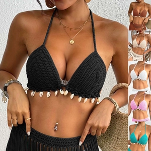 Detail of crochet bikini top with handmade shells and fringe in multiple colors