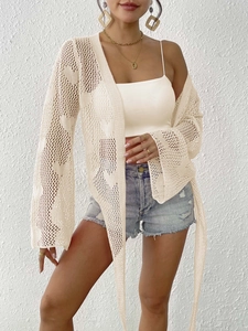 Detail of beige crochet knit cardigan featuring open mesh texture and flare sleeves