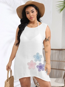 Detailed view of white plus size beach cover-up with delicate floral embroidery accents
