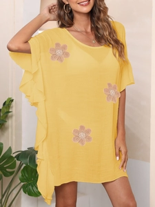 Detail of yellow beach dress with crochet flower appliques and ruffle batwing sleeves