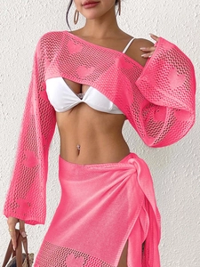 Detail of pink heart-pattern crochet mesh knit crop top and beach wrap skirt set
