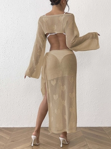 Detail of knitted beige hollow heart pattern on long sleeve top and wrap skirt set
