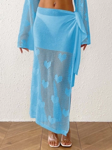 Detail of light blue crochet wrap skirt set featuring woven heart patterns and mesh texture