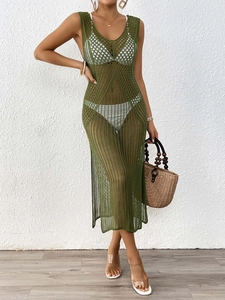 Detail view of the dark green crochet knit texture and hollow-out mesh on beach maxi dress