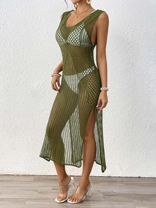 Detail of green knit beach cover-up featuring crochet texture and a high side slit