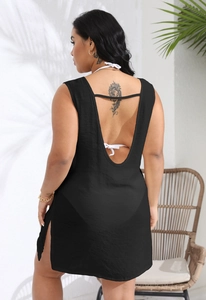 Detail of the open back design and side slit on a black beach cover-up dress