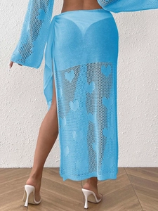 Detail of sky blue knit beach sarong featuring heart pattern and tie-waist design