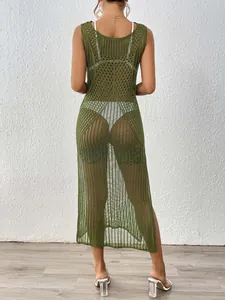 Detail of army green crochet knit beach dress featuring openwork weave and side slit