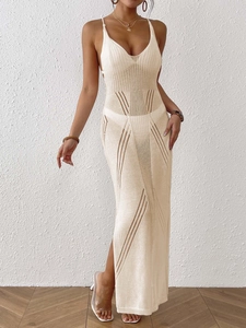 Elegant cream knit maxi dress with openwork details and halter neck for beach vacations