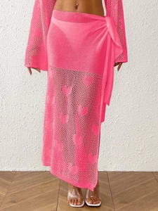 Detail showing heart-pattern crochet texture and side-tie waist on pink beach sarong