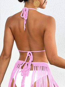 Detail view of pink crochet halter top and long fringe skirt set with knit textures