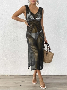 Detail of black hollow out crochet beach dress with mesh knit texture and side slit