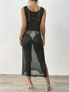 Detail shot of black crochet beach cover-up showing intricate mesh knit and side slit