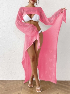 Detail of pink crochet beach set featuring heart cut-outs and lace-up wrap skirt texture