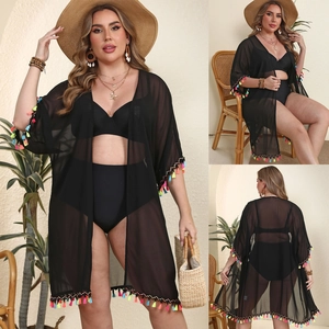 Detail view of black chiffon beach cover-up featuring colorful fringe tassels and kimono sleeves