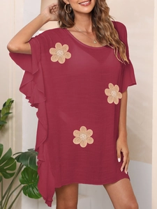 Close-up of wine red summer dress featuring ruffle sleeves and beige floral embroidery