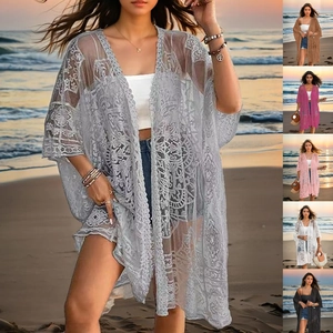Detailed close-up of intricate lace embroidery and floral patterns on women's beach cardigan