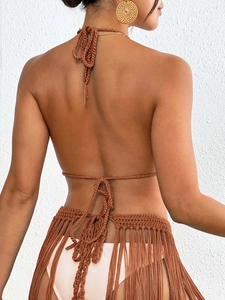 Detailed back view of brown crochet halter top with long tassels and intricate knit texture