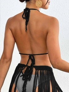 Detailed back view of black crochet halter top with long fringe skirt and tie-up design