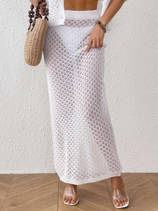 Detail of white crochet knit maxi skirt with hollow out texture and rib knit waistband