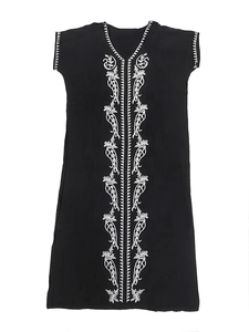 Close-up of white floral embroidery on a black V-neck bohemian beach cover-up dress
