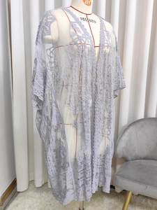 Detail of light purple sheer mesh lace cardigan with floral embroidery on dress form