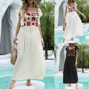 Detailed patchwork crochet floral design on a bohemian beach dress with ruffle sleeves