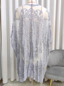Detailed back view of lilac crochet lace cardigan showing intricate floral patterns