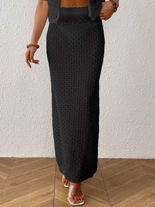 Close-up of black crochet knit texture on a sexy high-waisted hollowed-out maxi skirt