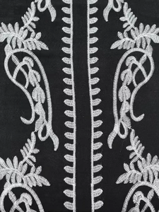Detailed view of intricate white floral embroidery on premium black cotton beach cover-up