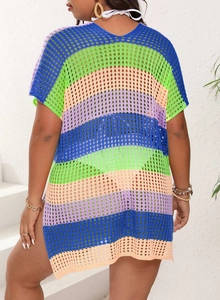 Detail of colorful rainbow knit beach cover-up featuring crochet mesh and side slits