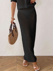Women's black crochet 2-piece set featuring a hollow knit crop top and high waist maxi skirt