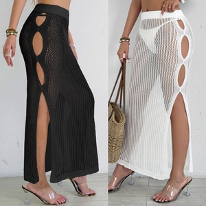 Detail of crochet knit beach skirt featuring side circular cut-outs and high side slit