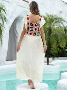 Detailed back view of crochet patchwork and ruffle sleeves on beach maxi dress