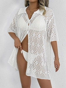 Close-up of white crochet hollow-out polo cardigan with stylish round buttons