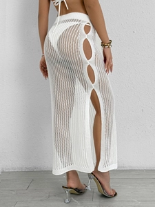 Detailed close-up of white crochet beach skirt featuring side cut-outs and high side slit