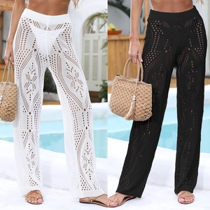 Detail of crochet hollow patterns on ivory and black wide-leg beach pants for women