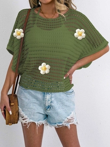 Detail of green hollow knit blouse with 3D white flower crochet and mesh texture