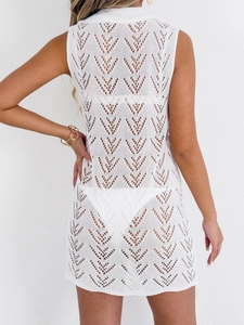 White crochet mini beach dress featuring sleeveless design and heart patterns