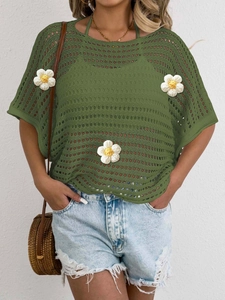 Close-up of olive green mesh knit top with 3D white floral appliques and cutout details