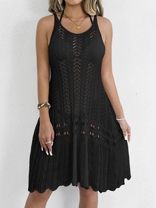 Black crochet knit halter neck dress featuring intricate hollow patterns for beach style