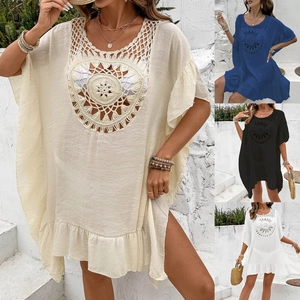 Close-up of bohemian crochet hollow pattern and tassel details on the beach cover-up dress