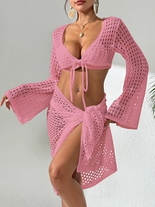 Detail of pink crochet two-piece beach set featuring tie-front top and cutout wrap skirt