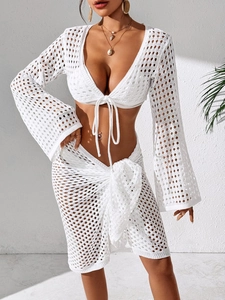 Detail view of the white crochet knit beach set showing delicate lace texture and tie-front