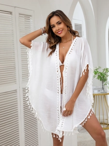 Bohemian white beach cover-up with tassel trim and lace detail for vacation