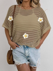 Detail of bohemian khaki hollow-out crochet top with oversized sleeves and denim shorts